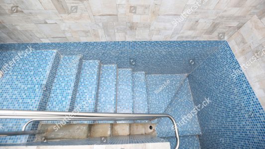 stock-photo-blue-tiled-mikveh-or-ritual-bath-with-railing-and-steps-is-used-by-jews-for-purification-1011258061